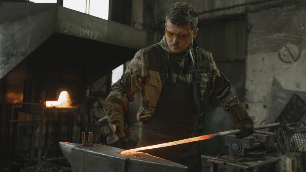 Blacksmith in yellow safety glasses