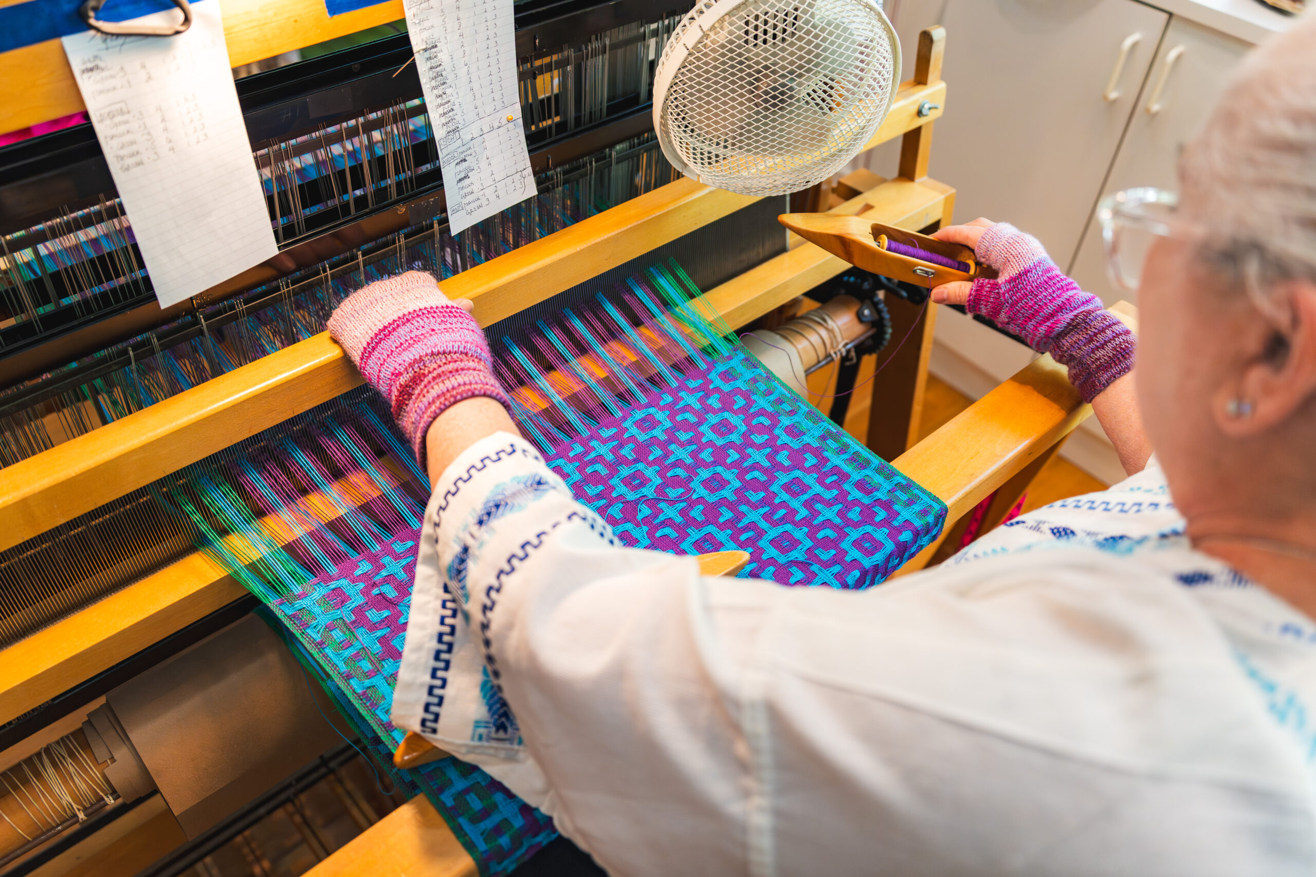 Student weaving on the floor loom at the Brookfield Craft Center.